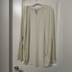 Cream colored cardigan with crochet detail on sleeves